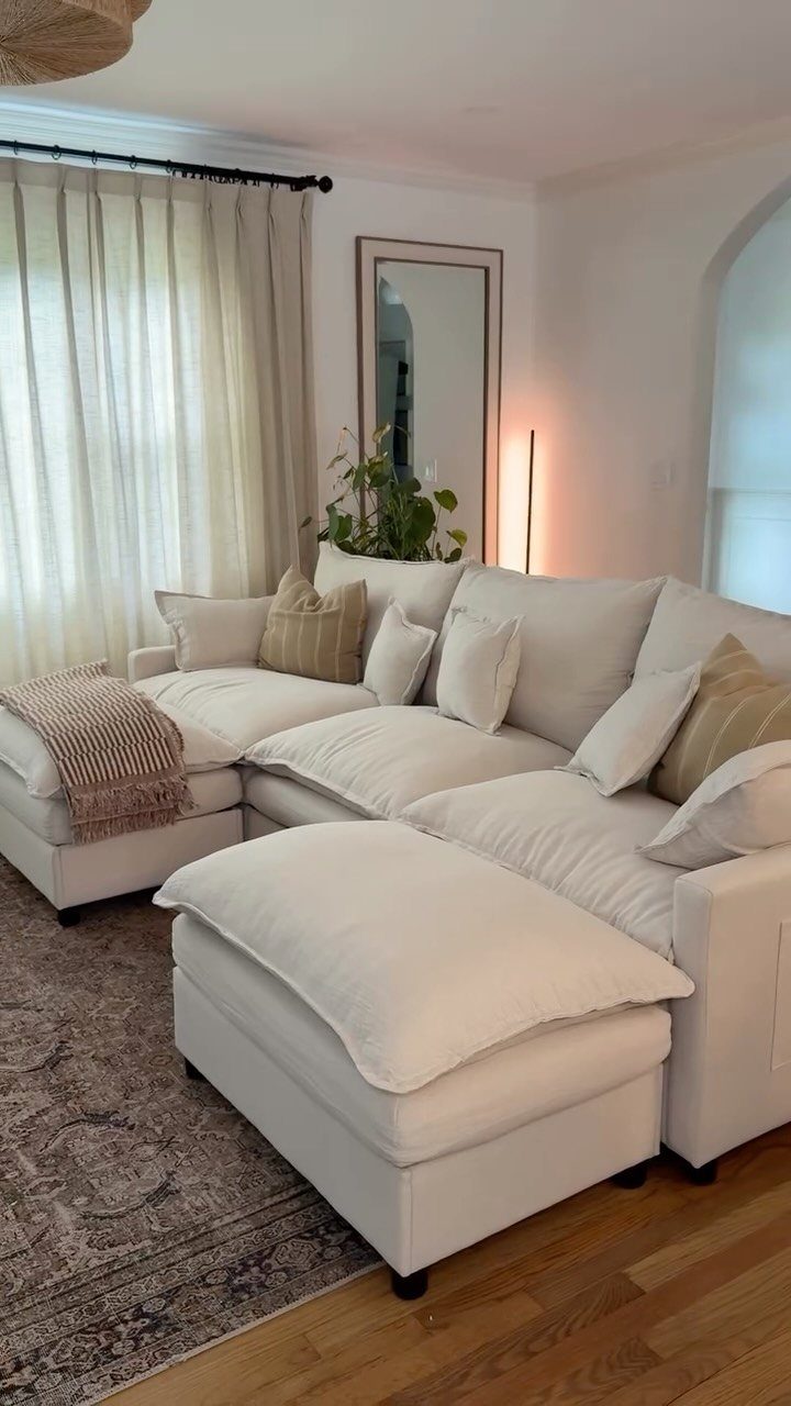 15 Living Room Natural Design Ideas with Organic Style 10 White linen sectional sofa with neutral pillows in a bright, natural living room.