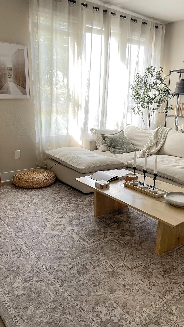 15 Living Room Natural Design Ideas with Organic Style 5 Bright living room with cream sofa, light wood coffee table, and sheer white curtains.