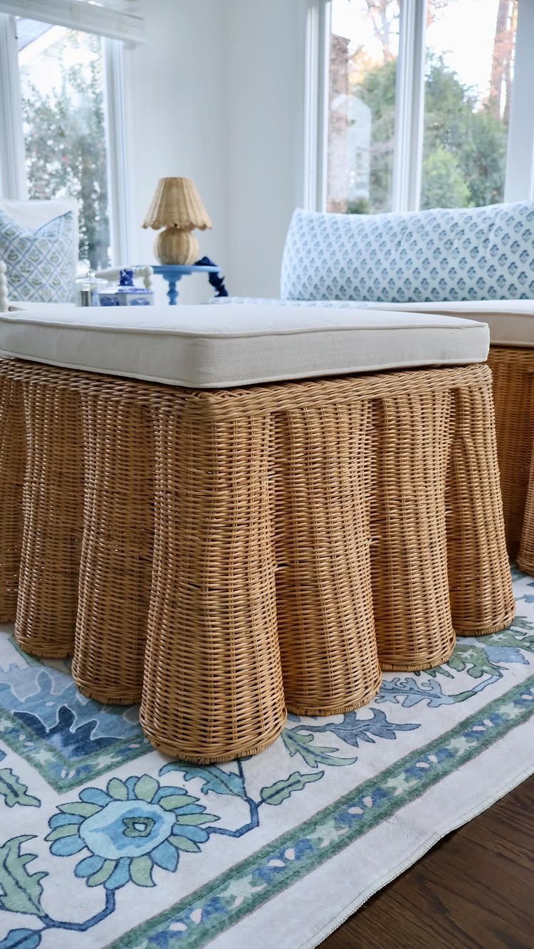 15 Living Room Natural Design Ideas with Organic Style 13 Scalloped wicker ottoman with white cushion on a blue floral patterned rug
